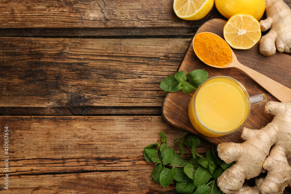 Flat lay composition with immunity boosting drink on wooden table. Space for text Flat lay composition with immunity boosting drink on wooden table. Space for text