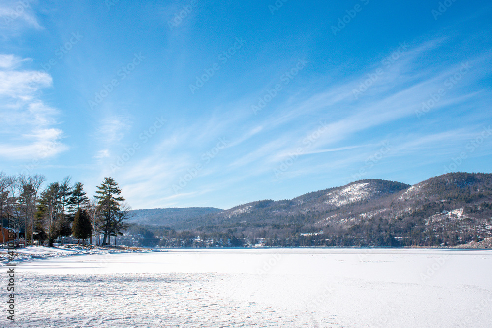 Winter scene with a frozen lake near the mountains Winter scene with a frozen lake near the mountains