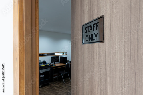 Warning sign in front of the door with a message for staff only with inside the sound control room.