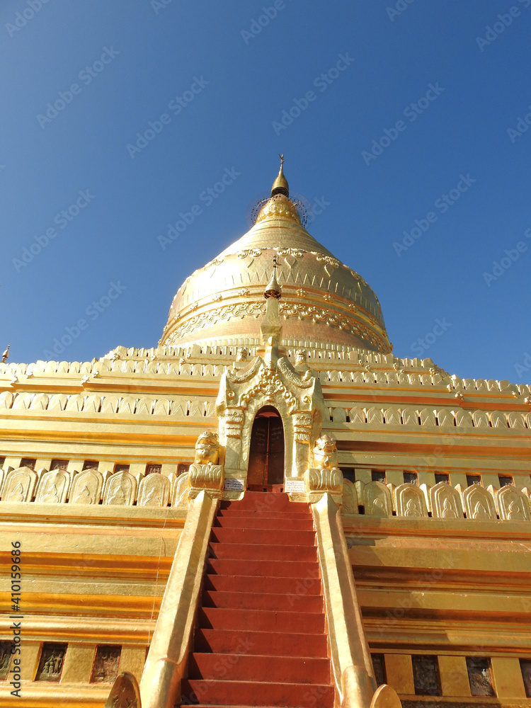 Bagan, Myanmar - november 2019: The Shwezigon Pagoda or Shwezigon Paya is a Buddhist temple located in Nyaung-U, a town near Bagan, in Myanmar. Bagan, Myanmar - november 2019: The Shwezigon Pagoda or Shwezigon Paya is a Buddhist temple located in Nyaung-U, a town near Bagan, in Myanmar.