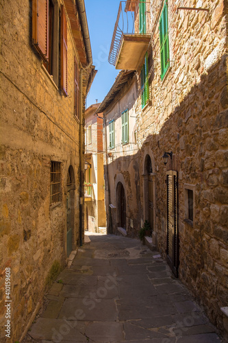 Fototapeta Naklejka Na Ścianę i Meble -  A street of historic stone buildings in the village of Montemerano near Manciano in Grosseto province, Tuscany, Italy
