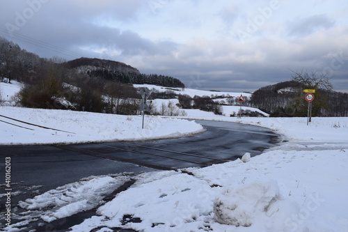 kurvige Eifelstraße im Schnee photo