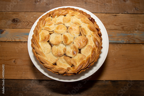 A golden brown delicious spiced Apple and Stem Ginger Pie on a wooden kitchen table