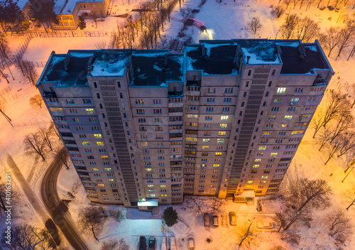 Winter evening aerial view to old skyscraper in residential area in Kharkiv photo