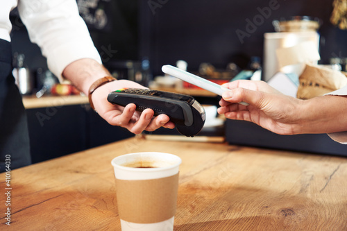 Contactless mobile payment with phone at cafe