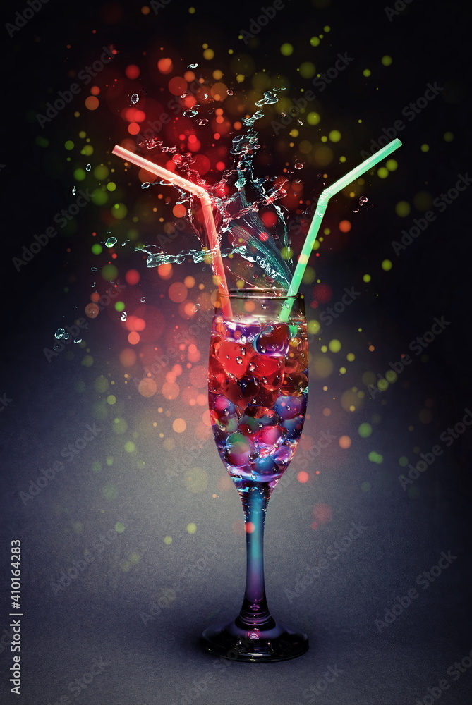 festive still life cocktail for lovers from a glass with hearts with a straw for a wedding or Valentine's day or March 8.