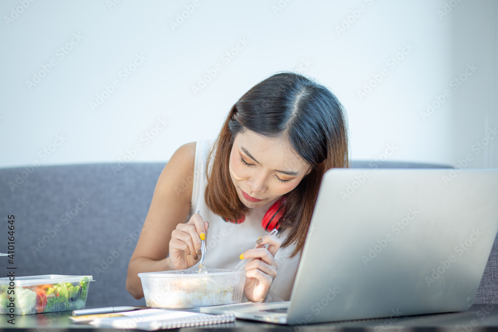 Young attractive asian female hungry eat doughnut take away snack food with full mouth look at computer notebook at home in busy work from home multitask unhealthy meal lifestyle concept.
Young attractive asian female hungry eat doughnut take away snack food with full mouth look at computer notebook at home in busy work from home multitask unhealthy meal lifestyle concept.