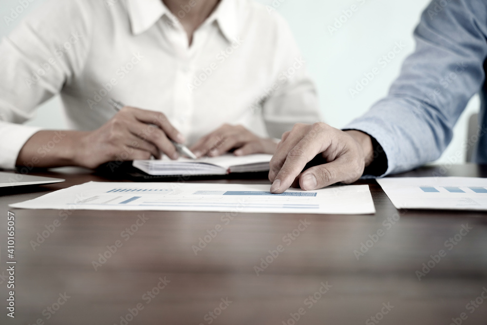 The businessman pointed to the company's marketing material The businessman pointed to the company's marketing material