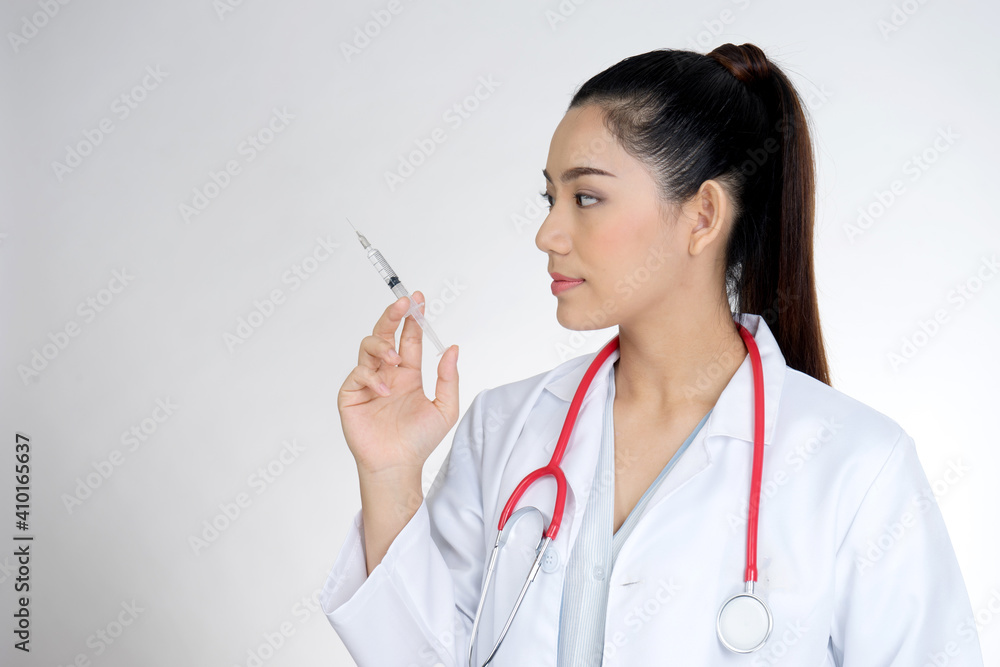 The female doctor was holding a syringe to prepare injections or Vaccine The female doctor was holding a syringe to prepare injections or Vaccine
