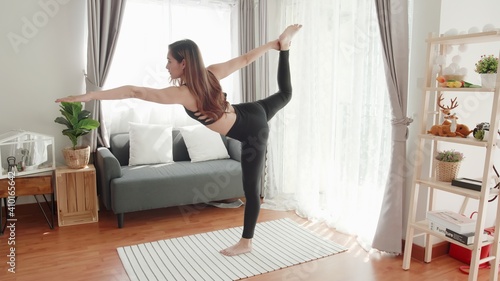 Young Asian women lovey with yoga exercise and stretching in the living room