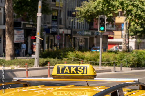 Izmir, Turkey. June 6, 2019: Roof of a yellow taxi and sign in the city. photo