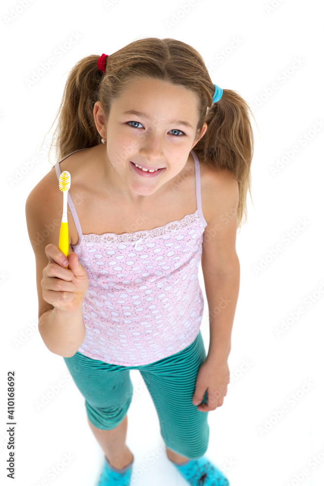 Smiling girl standing with toothbrush Smiling girl standing with toothbrush