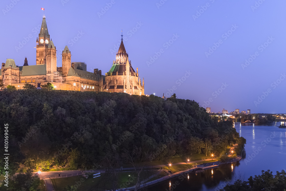 Evening twilight view from Alexandra Bridge Lookout of Parliament Hill and Parliament building in Ottawa, Ontario, capital of Canada.