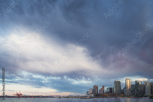 A dark, moody, stormy sky of cumulonimbus clouds hovers above the Vancouver city skyline in British Columbia, Canada on a summer evening. © Stephen