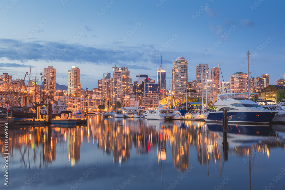 Evening cityscape view of Granville Island and Vancouver downtown waterfront skyline from Island Park Walk.