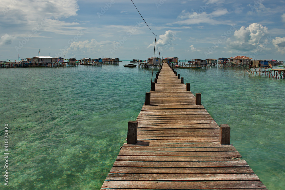 Semporna. Malaysia. December 01, 2018. Wooden walkways in a sea gypsy village on one of the many reef islands. Only on them you can get to the residential buildings of the village.