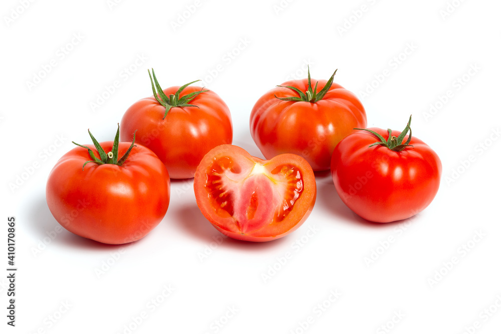 a group of tomatoes on a white background, with shadows. One tomato cut, studio photo, isolate, tomatoes washed a group of tomatoes on a white background, with shadows. One tomato cut, studio photo, isolate, tomatoes washed