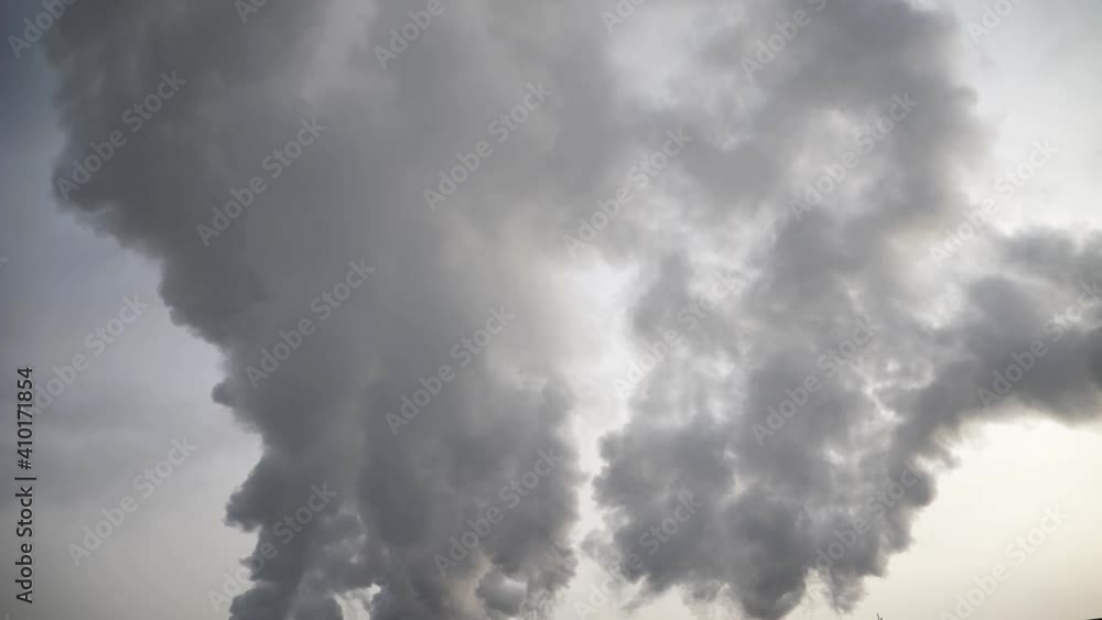 Large amounts of smog and smoke evaporate in the sky in close-up. Large amounts of smog and smoke evaporate in the sky in close-up.