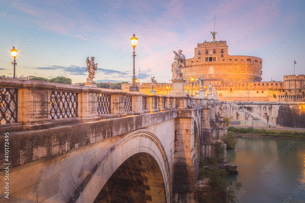 View across St. Angelo Bridge over the River Tiber looking towards Castel Sant'Angelo at sunset in Rome, capital city of Italy in the Lazio region.