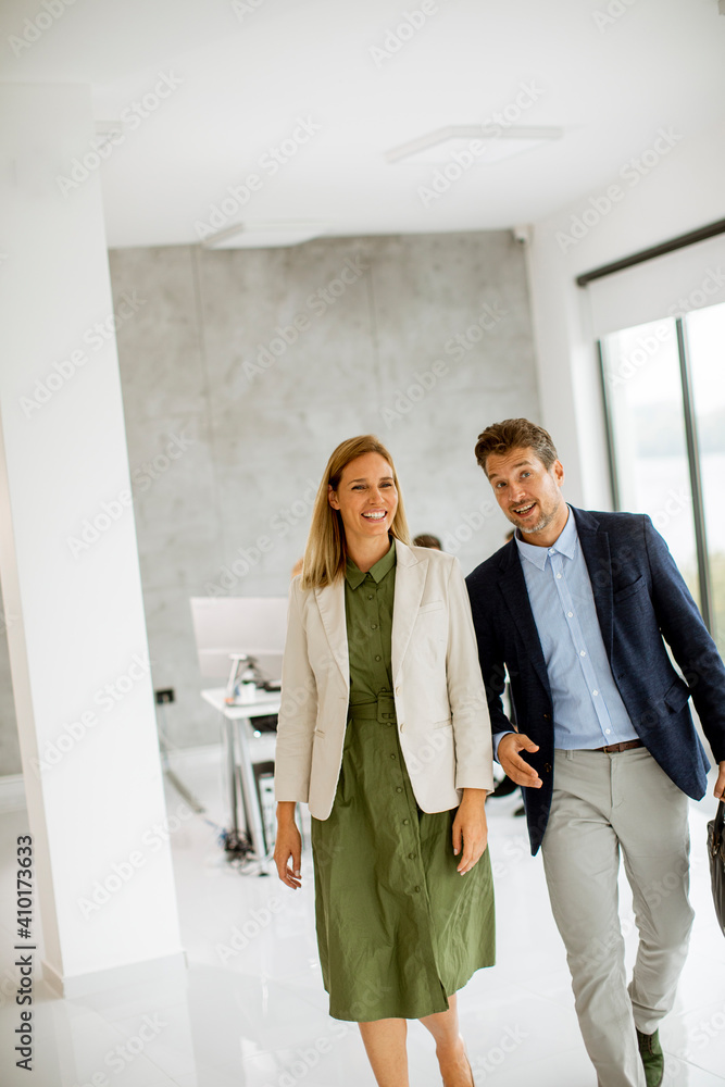 Young business couple walking together at office space Young business couple walking together at office space