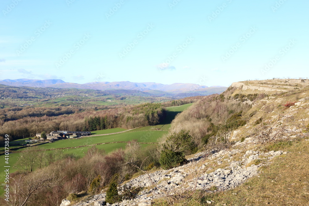 Naklejka premium View from Scout Scar, Cumbria, across the Lyth Valley towards the mountains of the central Lake District National Park.