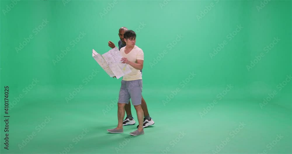 Two men walking with map, looking around and pointing, greenscreen Two men walking with map, looking around and pointing, greenscreen