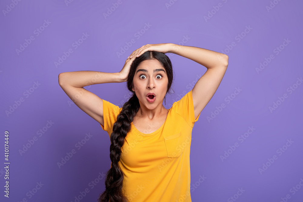 Fototapeta premium Close up portrait of shocked young indian woman screaming