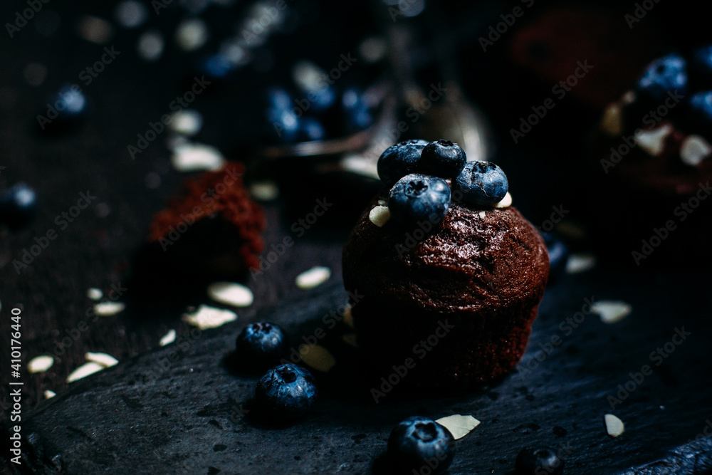 Chocolate muffin with blueberries on a dark background