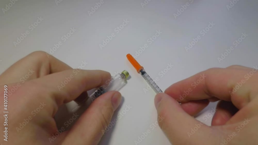 the close up of a man putting a syringe and a medical ampoule on the table the close up of a man putting a syringe and a medical ampoule on the table