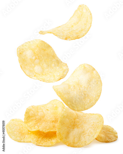 Potato chips are falling on a heap on a white background. Isolated photo