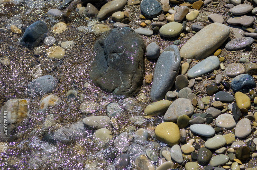 pebble stones on the sea beach, the rolling waves of the sea with foam pebble stones on the sea beach, the rolling waves of the sea with foam