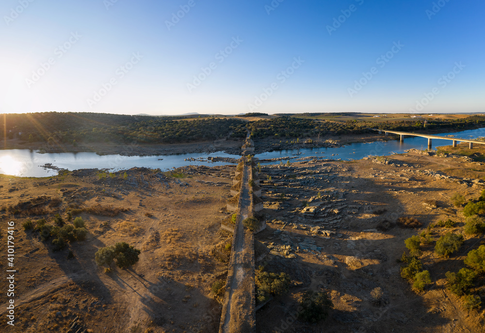 Destroyed abandoned Ajuda bridge drone aerial view, crossing the Guadiana river between Spain and Portugal