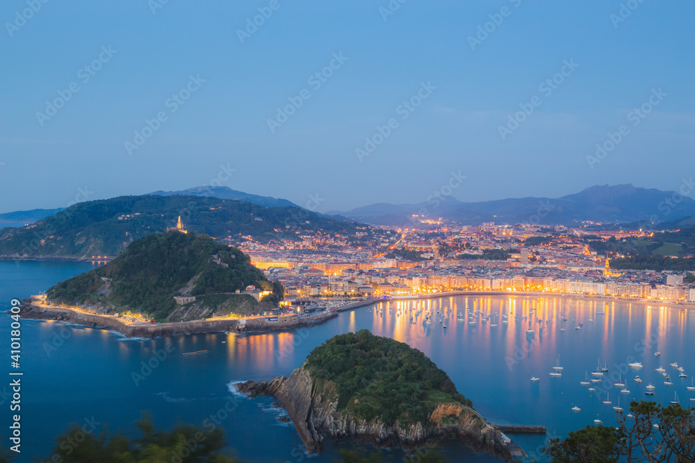 Classic evening cityscape view of Ondaretta and La Concha beaches of San Sebastian, Basque country in Spain from high up at the Mirador del Monte Igueldo.