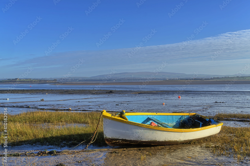 A beached yellow rowing boat at Sunderland Point