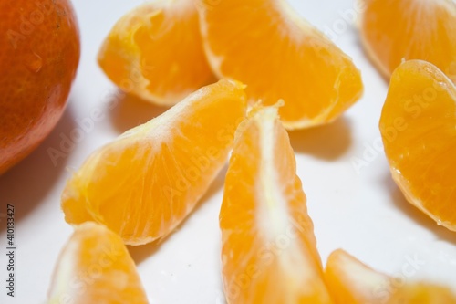 Isolated citrus segments. Collection of tangerine, orange and other citrus fruits peeled segments isolated on white background with clipping path
