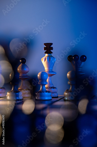 Chess board with chess pieces on blue background. Concept of business ideas and competition and strategy ideas. White king and queen close up.