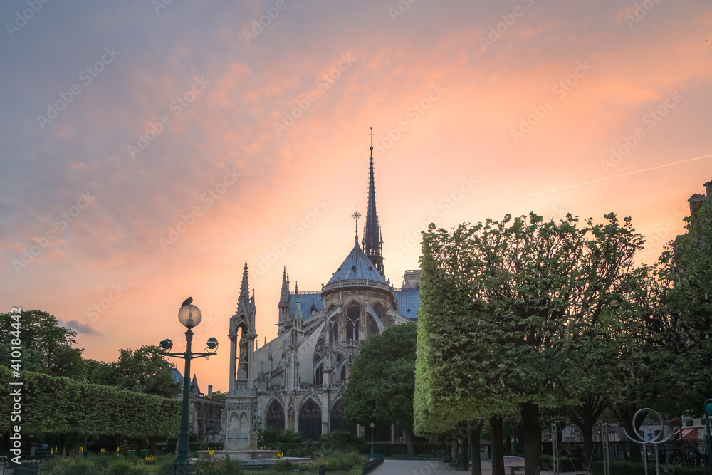 A backside view of the famous Notre Dame Cathedral on Ile de la Cite in Paris, France at sunset