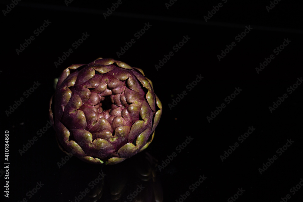 Fototapeta premium Isolated artichoke on black background