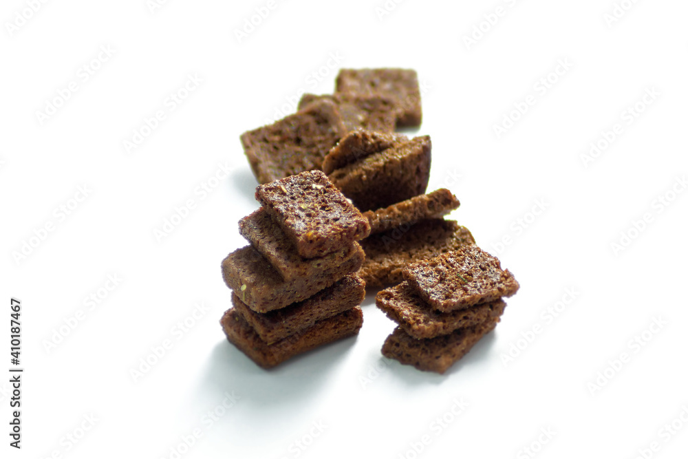 Black bread crackers lie on a white background Black bread crackers lie on a white background