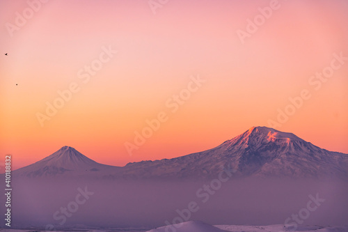 Beautiful winter landscape on the sunrise . The mountain peak snow-covered on the sunset.  Ararat mountain. photo