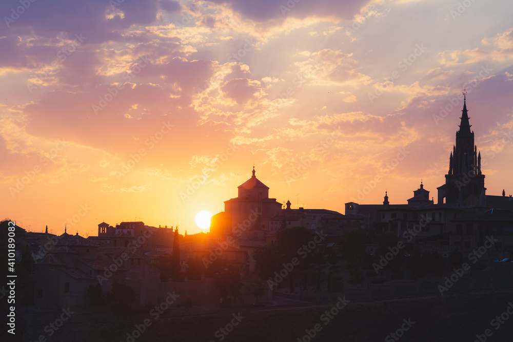 Silhouette of the skyline of historic Toledo, Spain at sunset.