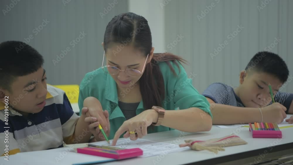 Education concept of 4k Resolution. The teacher is teaching disabled children to draw and paint. Education concept of 4k Resolution. The teacher is teaching disabled children to draw and paint.