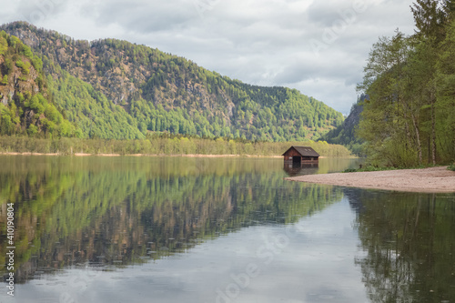 A lone boathouse on a calm day at Lake Almsee in Upper Austria's part of the Salzkammergut in the Almtal valley Fototapeta