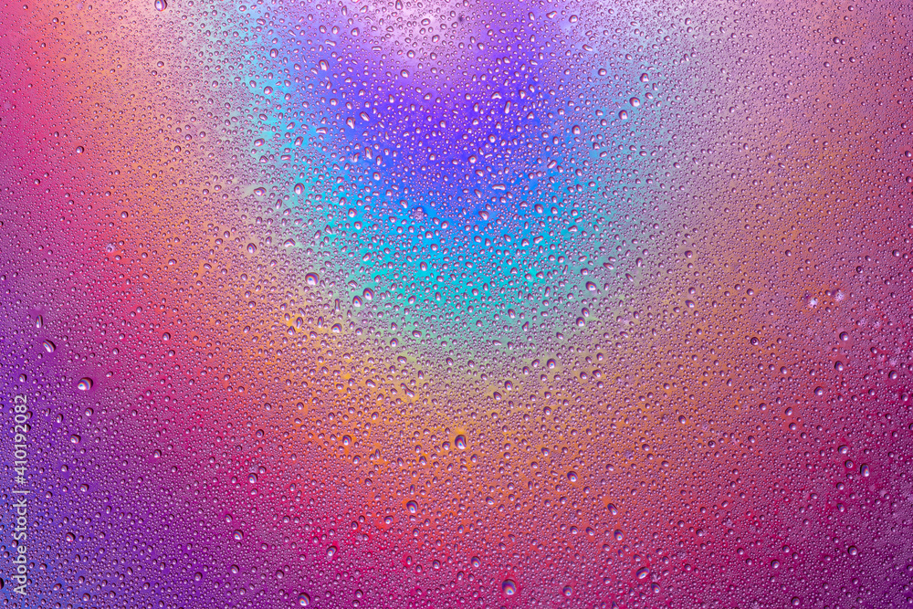 Fototapeta premium Background of drops of water on multicolor surface .