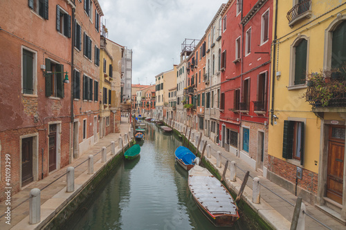 Boats parked along a quiet canal in Venice, Italy