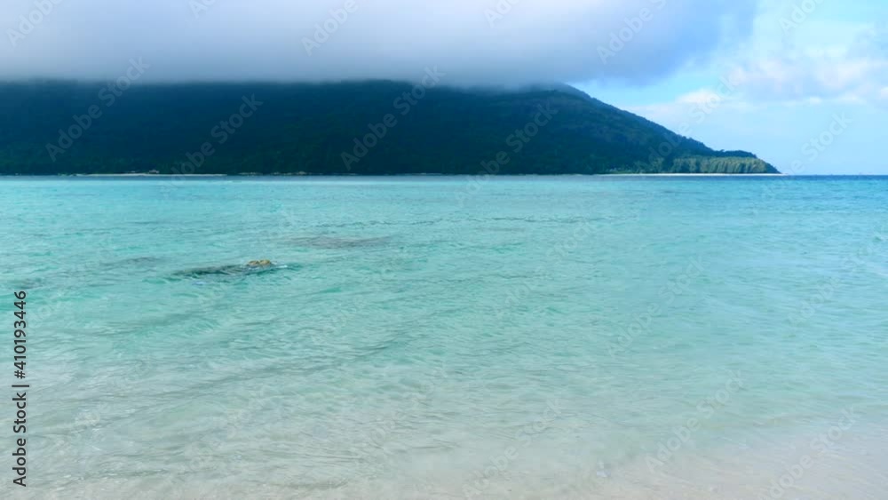 Vacation on Sea Beach with Clear Blue Water in Thailand. Ocean Beach with White Sand in Summer Day in Tropical Island Koh Lipe. Beautiful Crystal Sea and Green Jungle with Clouds on Background Vacation on Sea Beach with Clear Blue Water in Thailand. Ocean Beach with White Sand in Summer Day in Tropical Island Koh Lipe. Beautiful Crystal Sea and Green Jungle with Clouds on Background