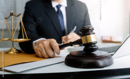 Business and lawyers discussing contract papers with brass scale on desk in office. Law, legal services, advice, justice and law concept picture with film grain effect