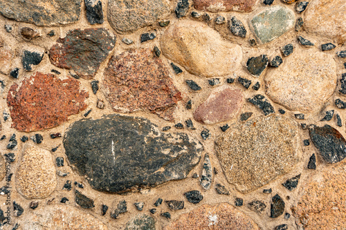 Close-up stone wall, cobblestone masonry, stone background, cobblestone pattern 