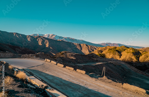 A road in the High Atlas Mountains in Morocco with snow-capped peaks in the background