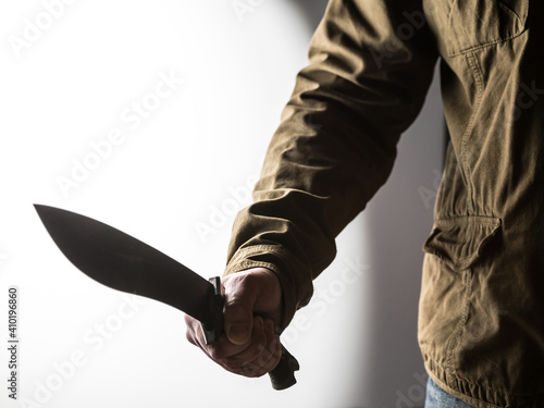 Man holding a machete in his hand photo